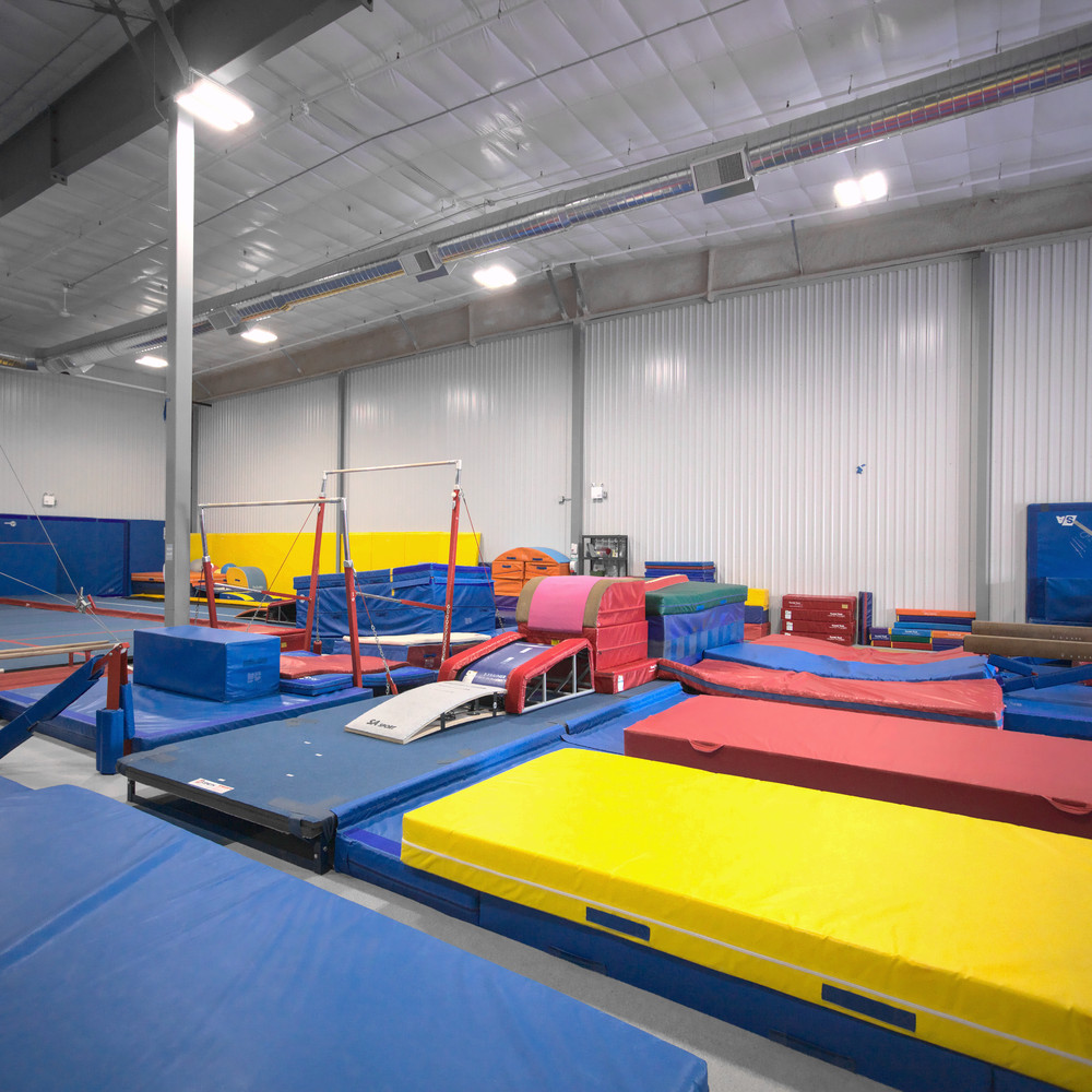 Gymworld Facility in Northwest London, professional gymnastics equipment - adjustable bars, balance beams, large spring floor, 40 ft. tumble track, 2 tumbling rods, vault table etc.