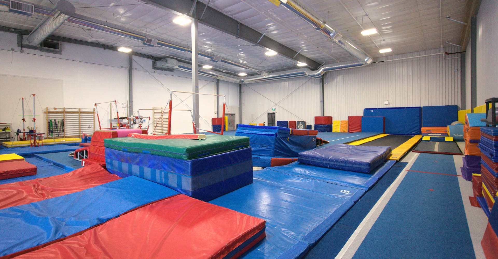 Gymworld Gymnastics Facility in Northwest London: Professional Equipment, Mats, Balance Beams, Adjustable Bars and More. Supportive Training Environment for Youth in London and region.