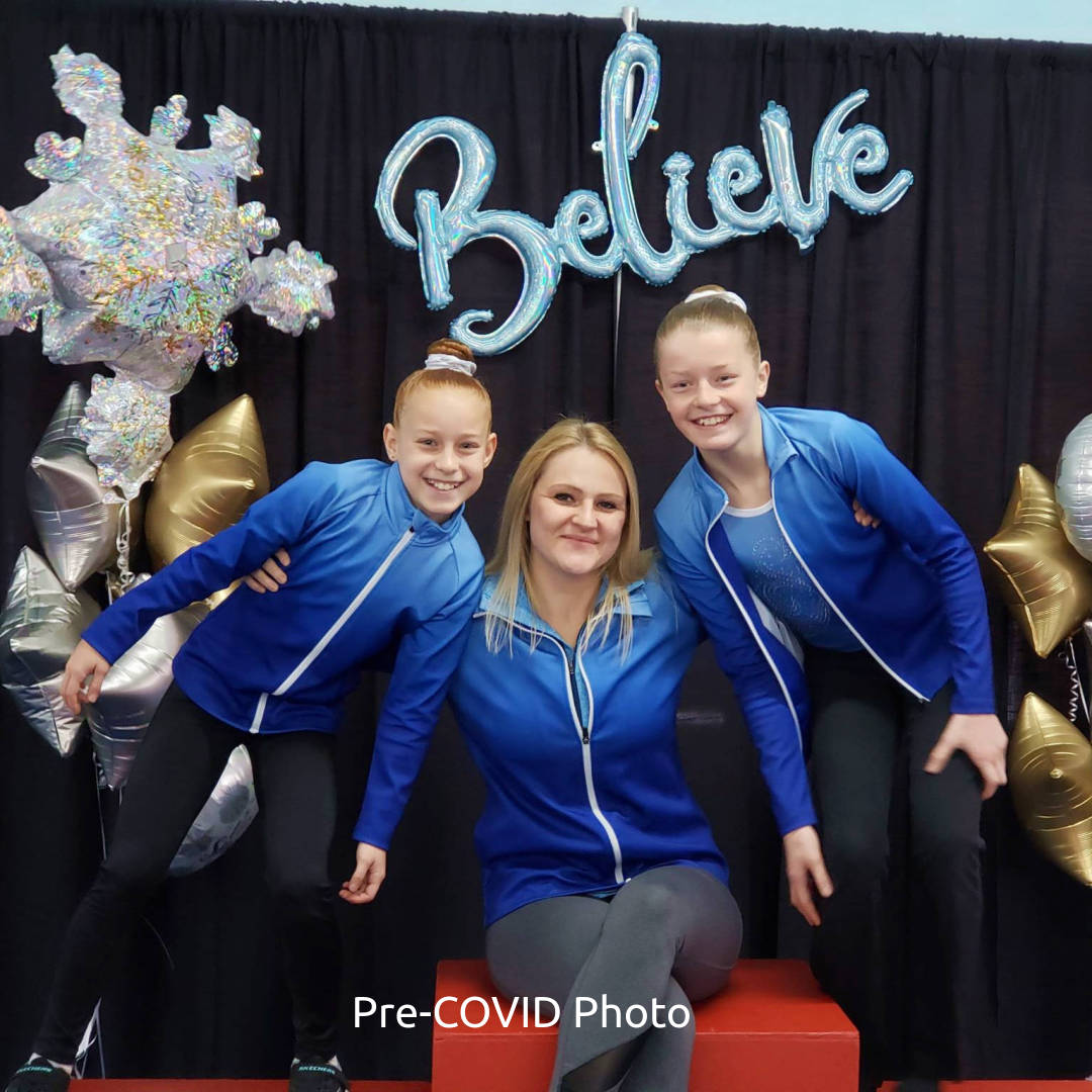 Allie, the Competitive Co-Ordinator and two GW Elites girls, posing on the podium.