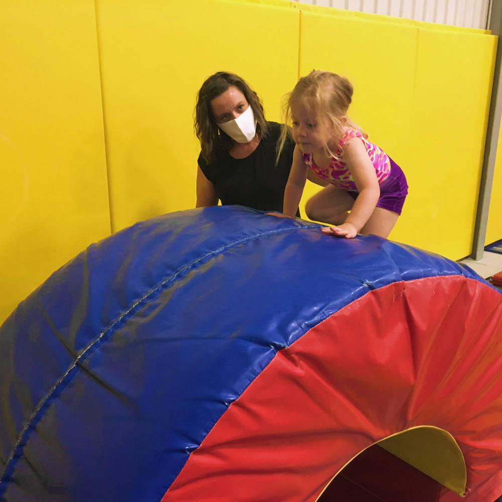 Gymworld gymnastics coaches do a group jump.